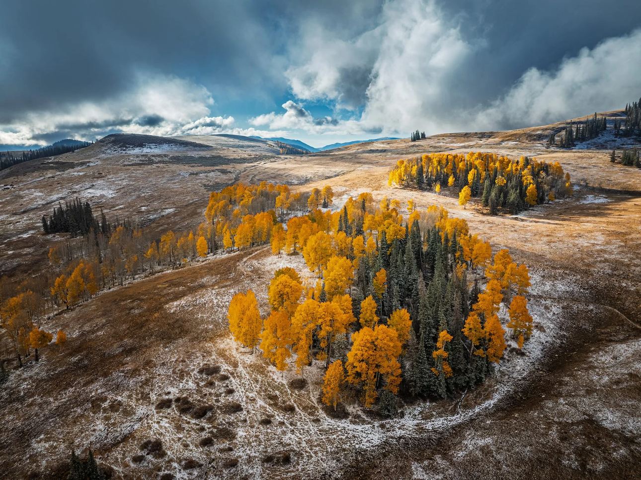 Aerial landscape photograph of autumn fall colors covered by the first snowfall, fine art print by Clint Losee