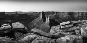 Black and white panorama of rugged sandstone towers and deep desert canyons in Canyonlands National Park.