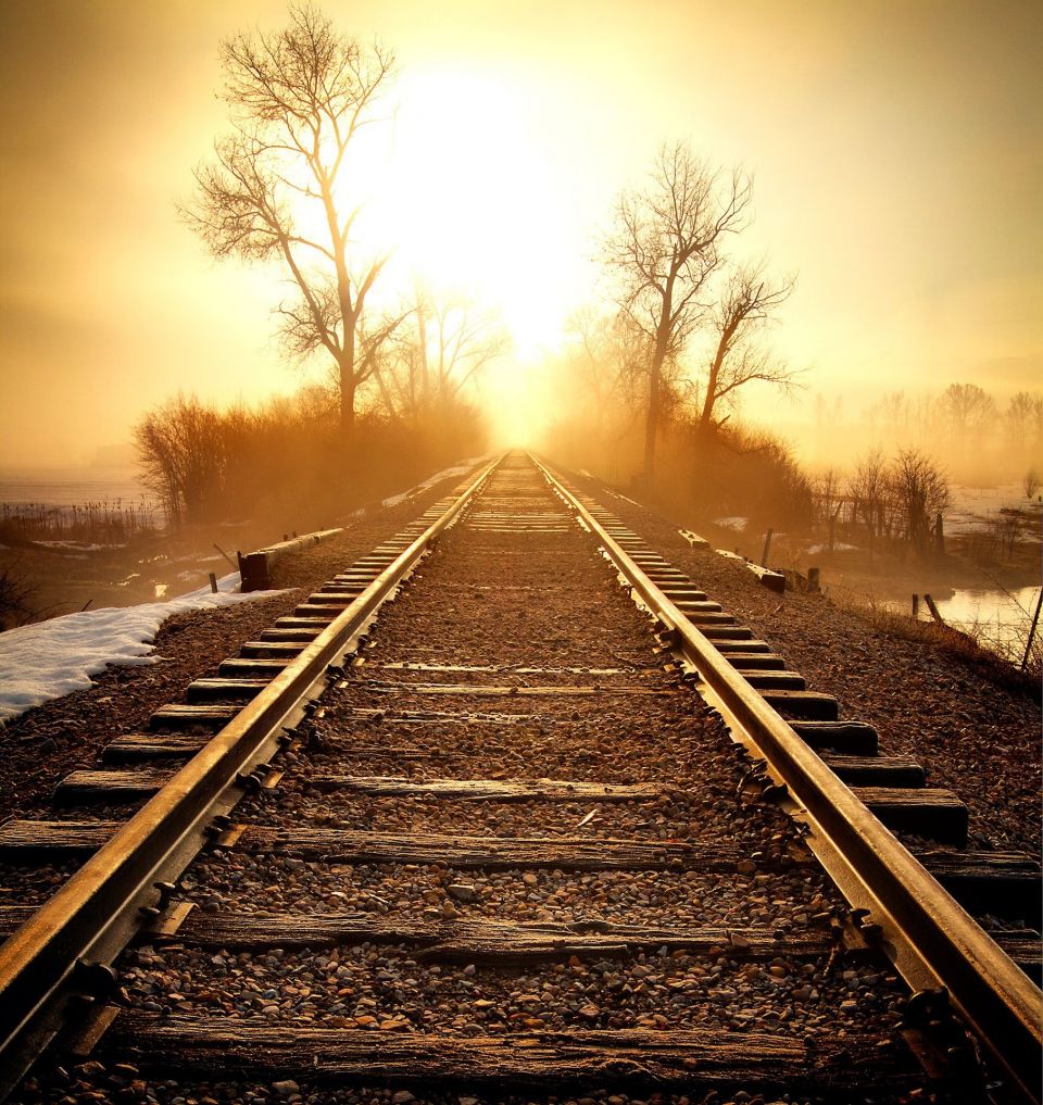 Railroad tracks into the early morning sun
